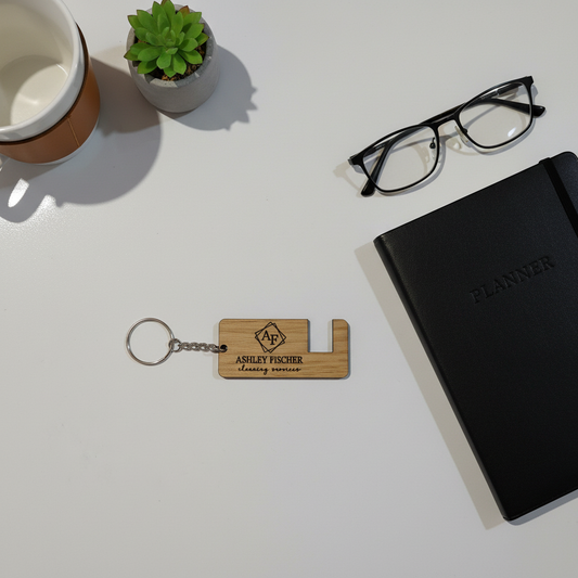 Phone stand keychain flatlay with office accessories